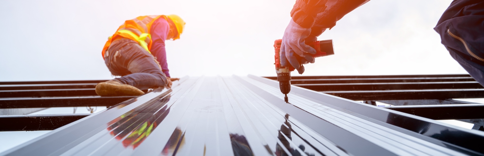 Close-up of workers using a nail gun