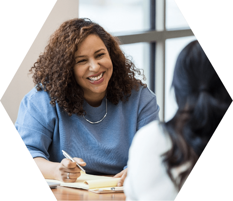 Woman smiling as she interviews a candidate