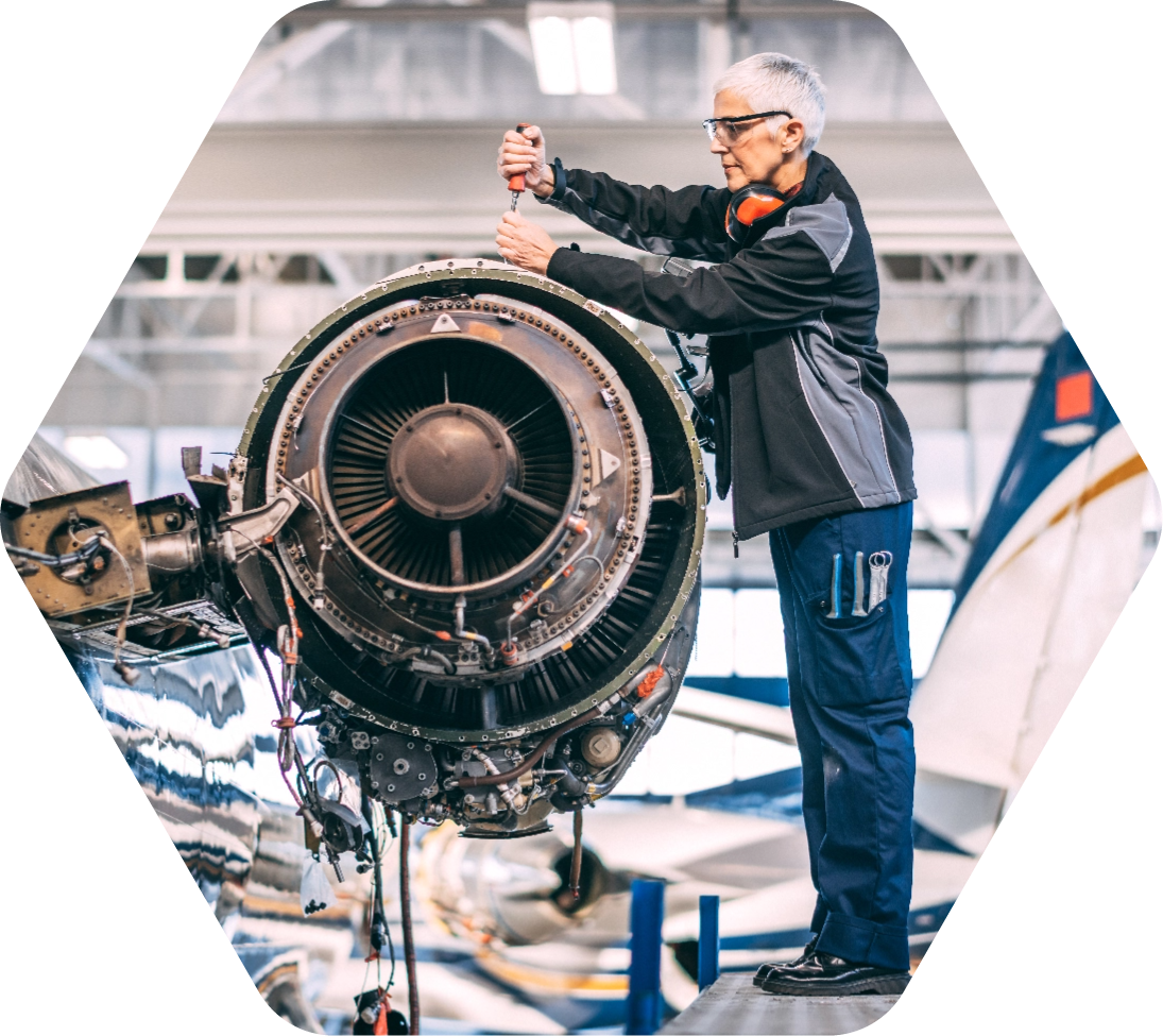 Woman working on an airplane engine