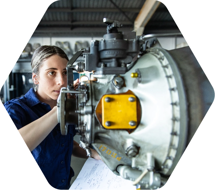 Woman installing parts on aircraft equipment