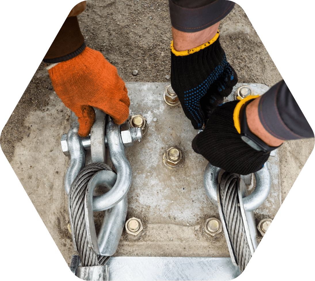 Gloved hands securing bracing hardware