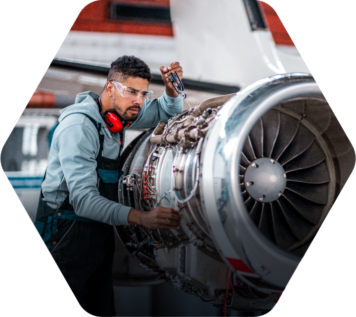 Technician working on an airplane engine