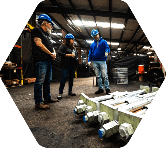 Group of people in hard hats on the manufacturing floor
