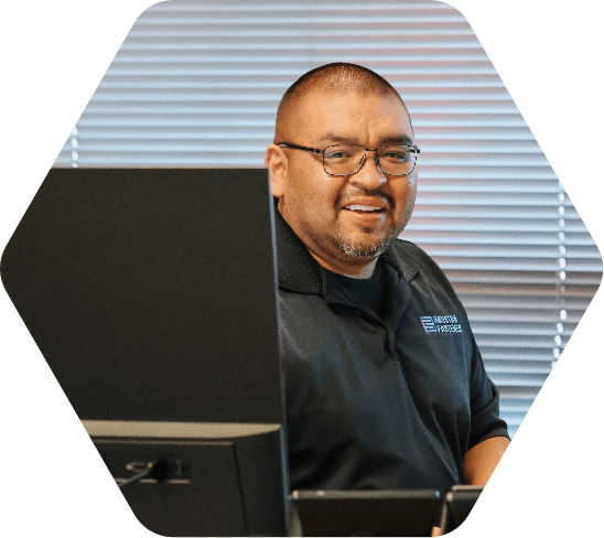 Smiling man seated at a desk