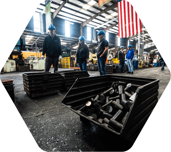 People in hard hats at a manufacturing facility